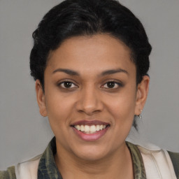 Joyful latino young-adult female with short  brown hair and brown eyes