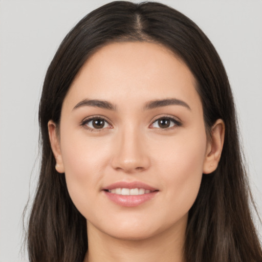 Joyful white young-adult female with long  brown hair and brown eyes