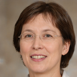 Joyful white adult female with medium  brown hair and grey eyes