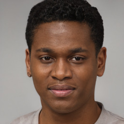 Joyful black young-adult male with short  brown hair and brown eyes