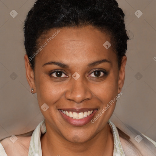 Joyful black young-adult female with short  brown hair and brown eyes