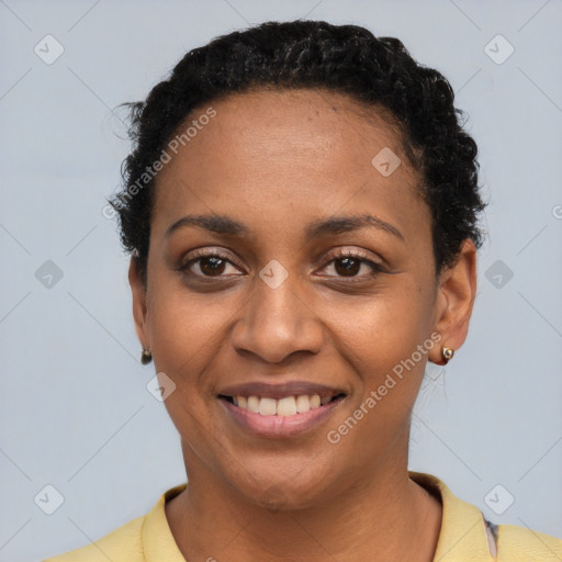 Joyful black young-adult female with short  brown hair and brown eyes