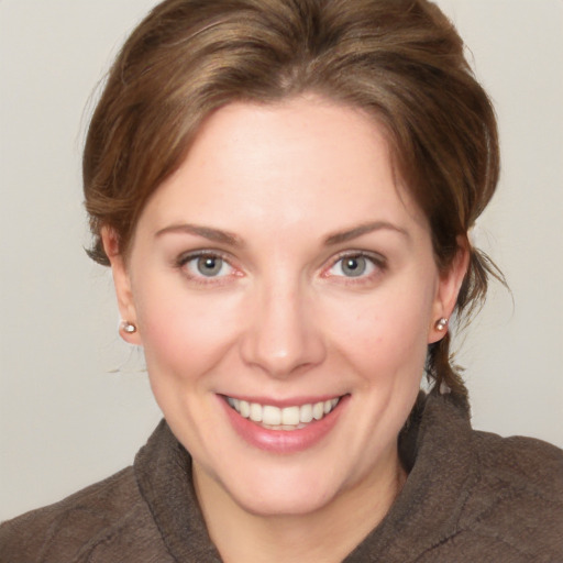 Joyful white young-adult female with medium  brown hair and green eyes