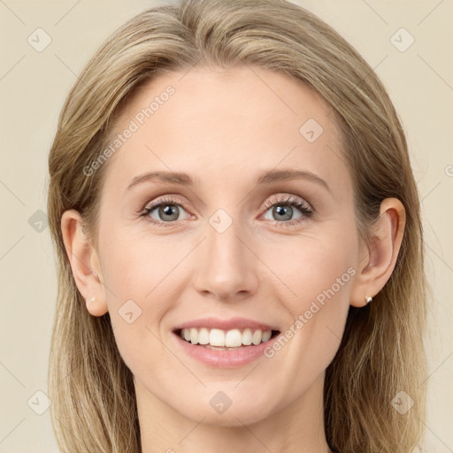 Joyful white young-adult female with long  brown hair and blue eyes