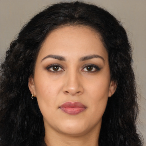 Joyful latino young-adult female with long  black hair and brown eyes