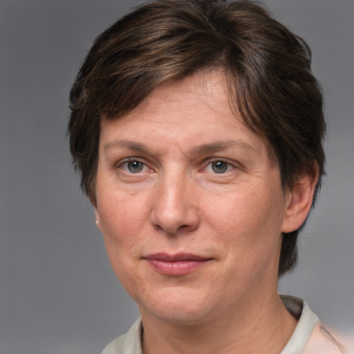 Joyful white adult female with short  brown hair and brown eyes