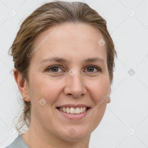 Joyful white adult female with medium  brown hair and grey eyes