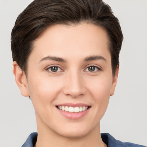 Joyful white young-adult female with short  brown hair and brown eyes