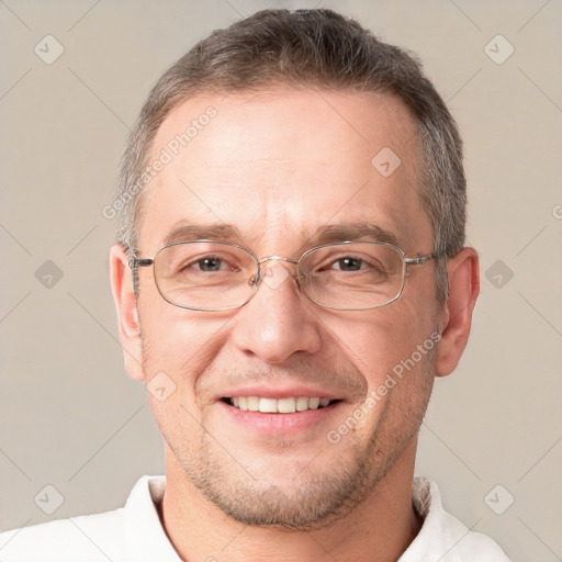 Joyful white adult male with short  brown hair and brown eyes