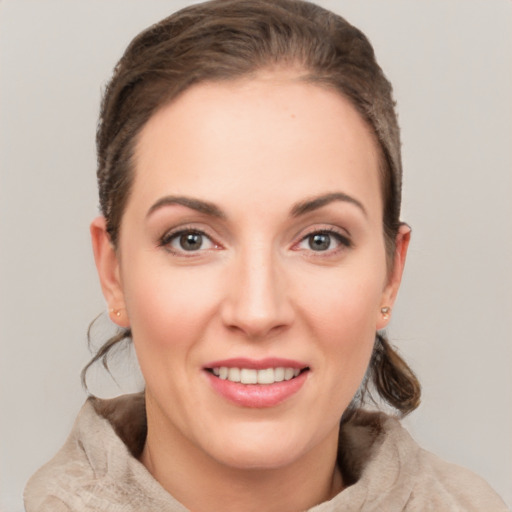 Joyful white young-adult female with short  brown hair and grey eyes