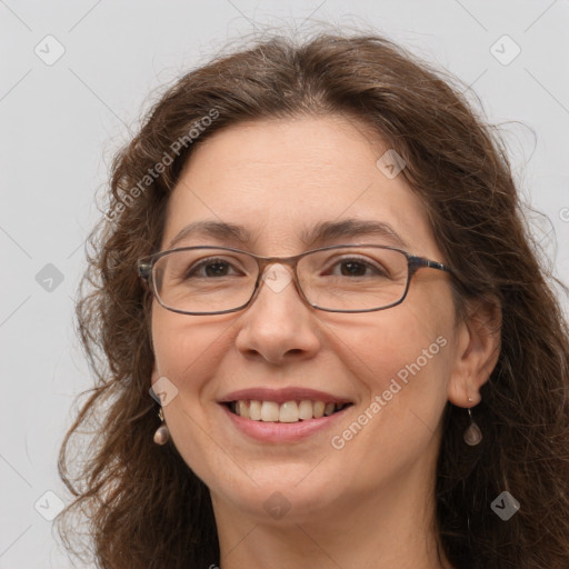 Joyful white adult female with long  brown hair and grey eyes