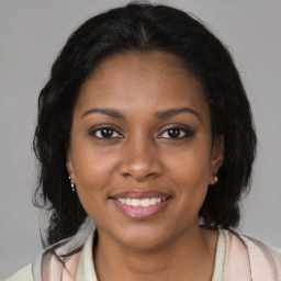 Joyful black young-adult female with medium  brown hair and brown eyes