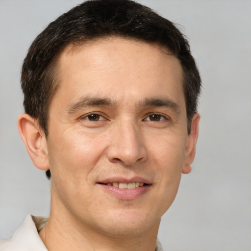 Joyful white adult male with short  brown hair and brown eyes