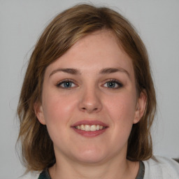 Joyful white young-adult female with medium  brown hair and blue eyes