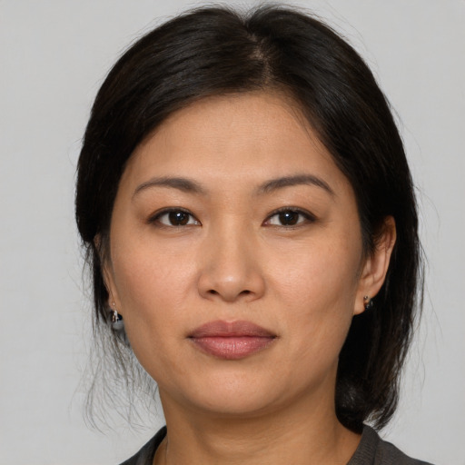 Joyful asian young-adult female with medium  brown hair and brown eyes