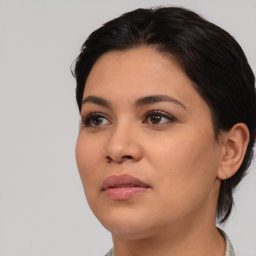 Joyful latino young-adult female with medium  black hair and brown eyes