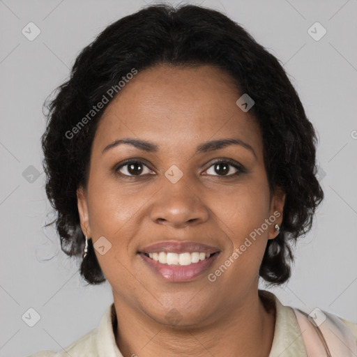 Joyful black adult female with medium  brown hair and brown eyes