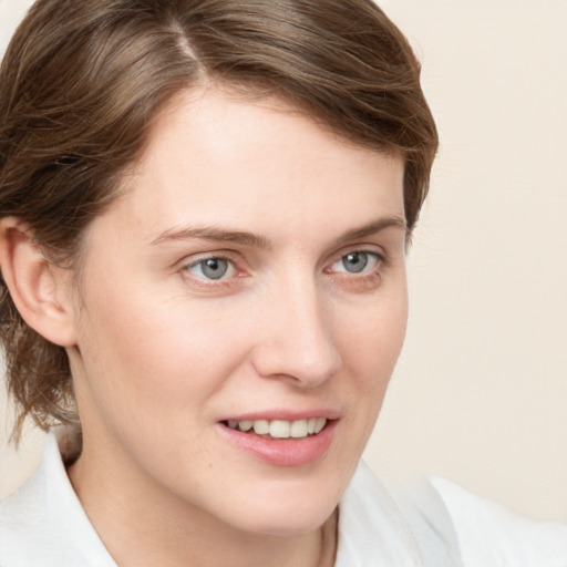 Joyful white young-adult female with medium  brown hair and grey eyes