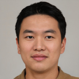 Joyful asian young-adult male with short  black hair and brown eyes