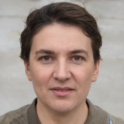 Joyful white adult male with short  brown hair and grey eyes