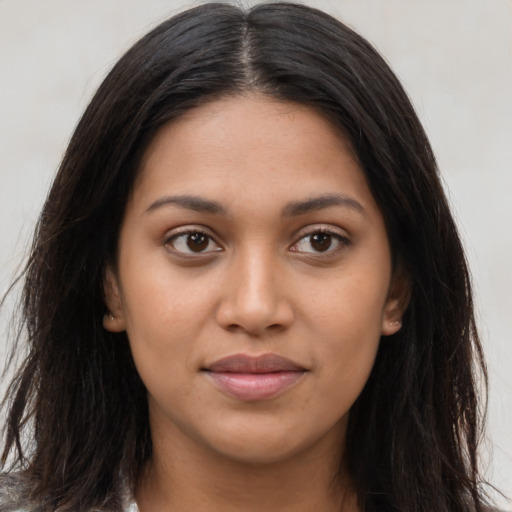 Joyful latino young-adult female with long  brown hair and brown eyes