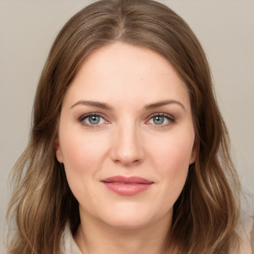 Joyful white young-adult female with long  brown hair and green eyes