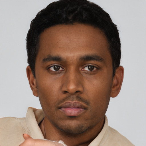 Neutral latino young-adult male with short  black hair and brown eyes
