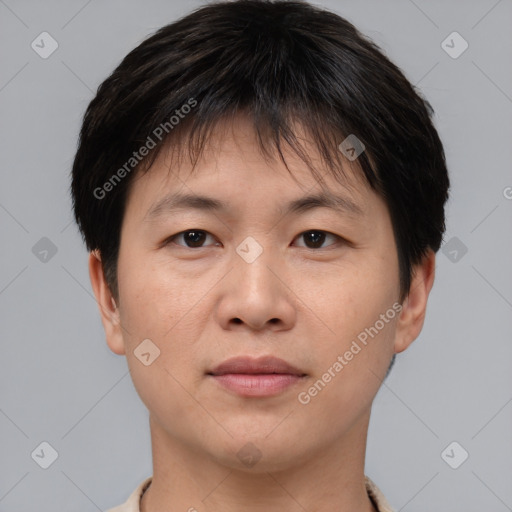 Joyful asian young-adult male with short  brown hair and brown eyes