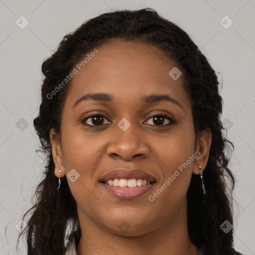 Joyful black young-adult female with long  brown hair and brown eyes