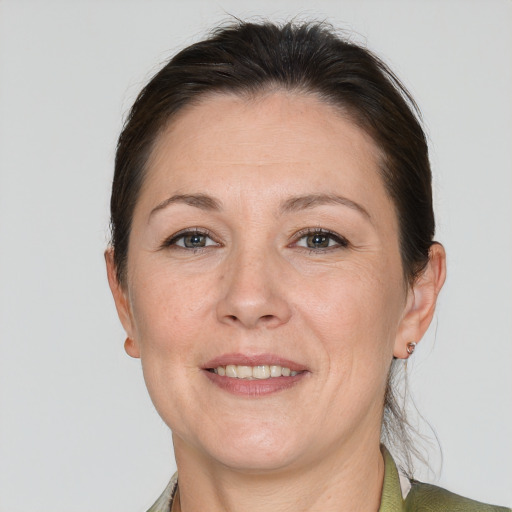 Joyful white adult female with short  brown hair and grey eyes