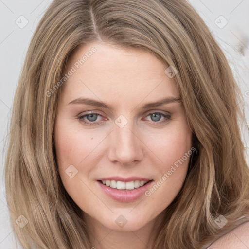 Joyful white young-adult female with long  brown hair and blue eyes