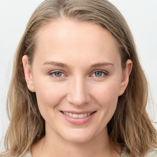 Joyful white young-adult female with long  brown hair and blue eyes