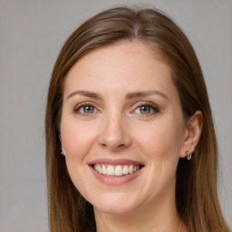 Joyful white young-adult female with long  brown hair and grey eyes