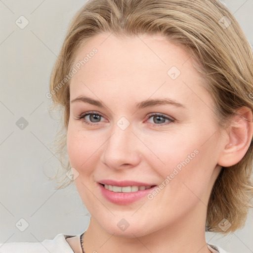 Joyful white young-adult female with medium  brown hair and blue eyes