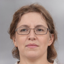 Joyful white adult female with medium  brown hair and grey eyes