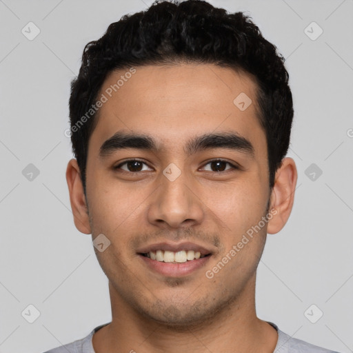 Joyful latino young-adult male with short  black hair and brown eyes