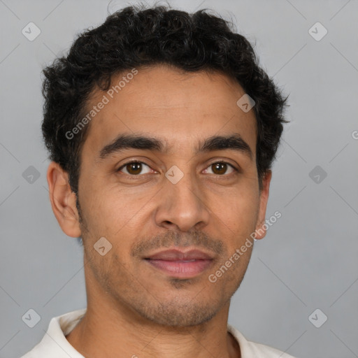 Joyful latino young-adult male with short  brown hair and brown eyes