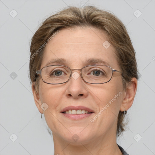 Joyful white adult female with medium  brown hair and blue eyes