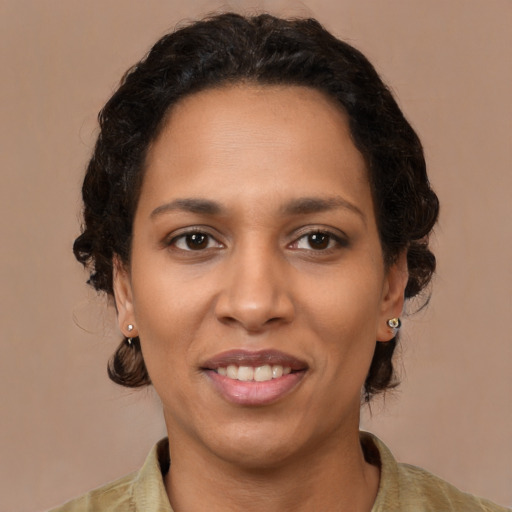 Joyful latino adult female with medium  brown hair and brown eyes