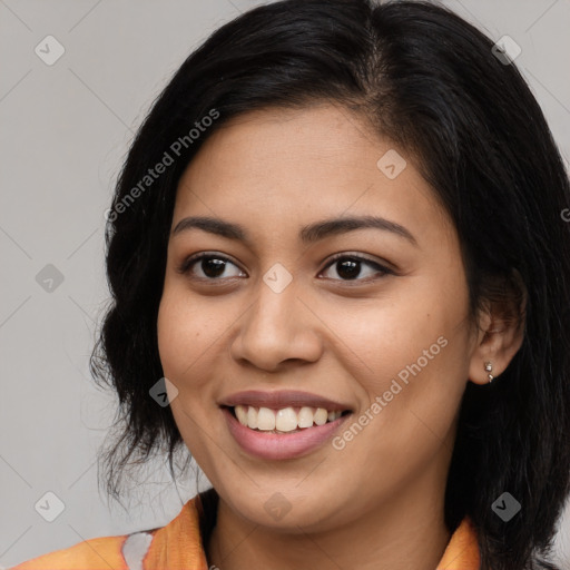 Joyful latino young-adult female with long  brown hair and brown eyes