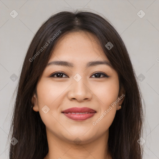 Joyful latino young-adult female with long  brown hair and brown eyes