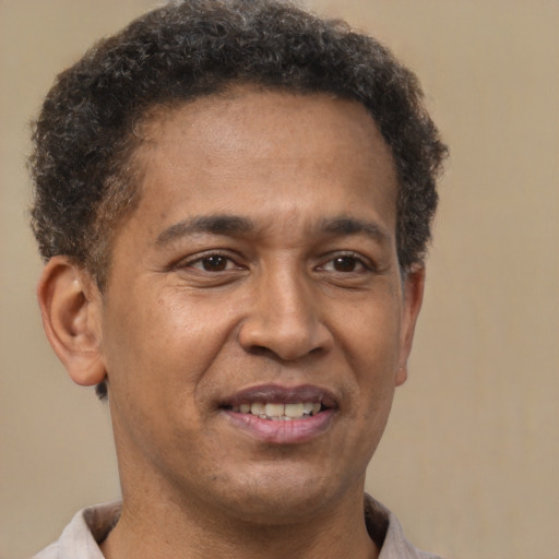 Joyful latino adult male with short  brown hair and brown eyes