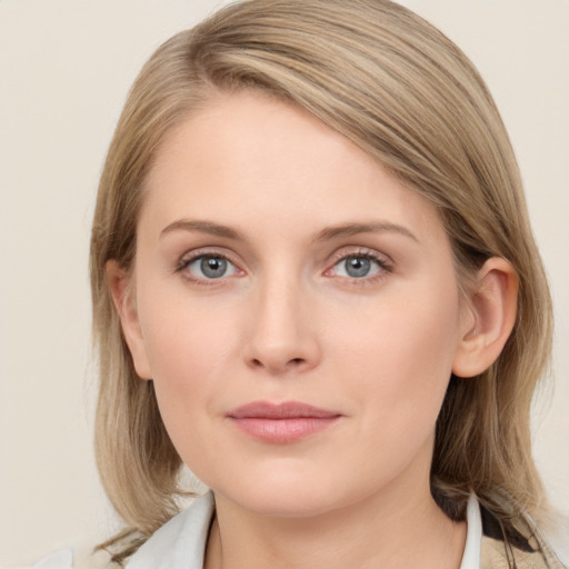 Joyful white young-adult female with medium  brown hair and blue eyes