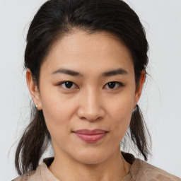 Joyful asian young-adult female with medium  brown hair and brown eyes