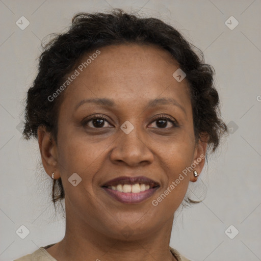 Joyful black adult female with medium  brown hair and brown eyes