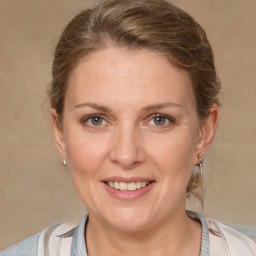 Joyful white adult female with medium  brown hair and grey eyes