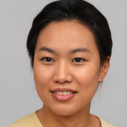 Joyful asian young-adult female with medium  brown hair and brown eyes