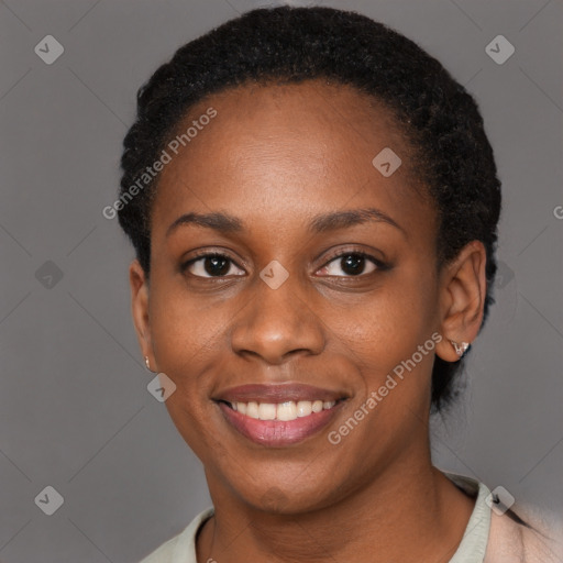 Joyful black young-adult female with short  black hair and brown eyes