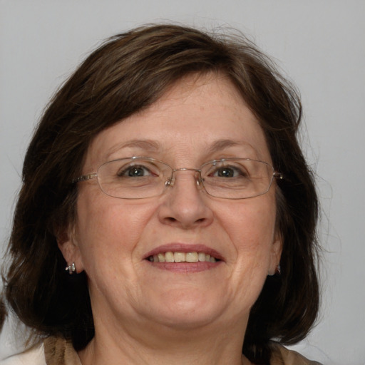 Joyful white adult female with medium  brown hair and blue eyes