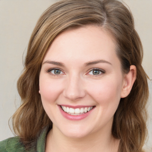 Joyful white young-adult female with medium  brown hair and green eyes